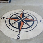 The homeowner, who is an avid Boatsman, requested a compass engraved in concrete then stained to enhance it's appearance.  This picture is the compass before it is sealed.