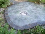 Custom colored granite stamped patio with fire pit