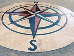 Compass engraved in concrete then stained.  This is a picture of the compass after it is sealed.  Have your business logo or symbol of your choice engraved in concrete!!